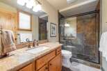 This stunning bathroom boasts a luxurious design with a granite countertop and a spacious shower.