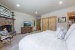 Step into luxury with this stunning bedroom featuring a cozy fireplace and a large, comfortable bed.