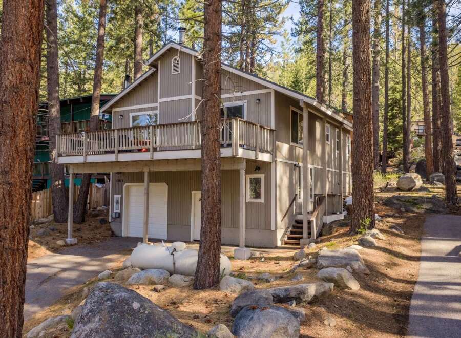 Nestled amidst towering trees, this charming home offers a serene retreat.