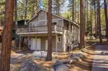 Nestled amidst towering trees, this charming home offers a serene retreat.