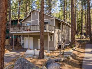 Nestled amidst towering trees, this charming home offers a serene retreat.