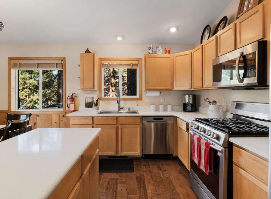 Step into this inviting kitchen, featuring beautiful wooden cabinetry and modern stainless steel appliances.