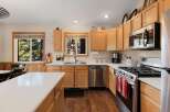 Step into this inviting kitchen, featuring beautiful wooden cabinetry and modern stainless steel appliances.