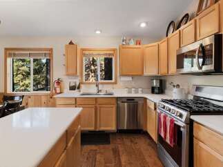 Step into this inviting kitchen, featuring beautiful wooden cabinetry and modern stainless steel appliances.