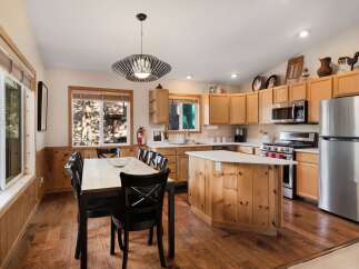 Step into this inviting kitchen, featuring a stylish island and ample counter space, perfect for culinary adventures.