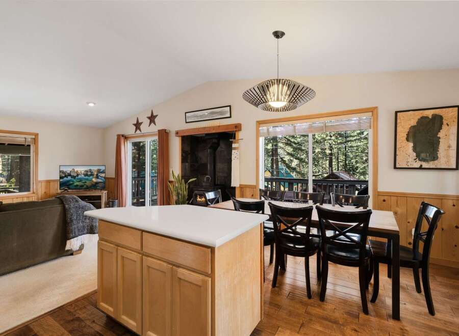 Step into this inviting home featuring a cozy fireplace and a modern kitchen island.