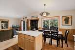 Step into this inviting home featuring a cozy fireplace and a modern kitchen island.