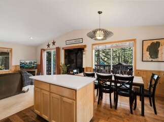 Step into this inviting home featuring a cozy fireplace and a modern kitchen island.