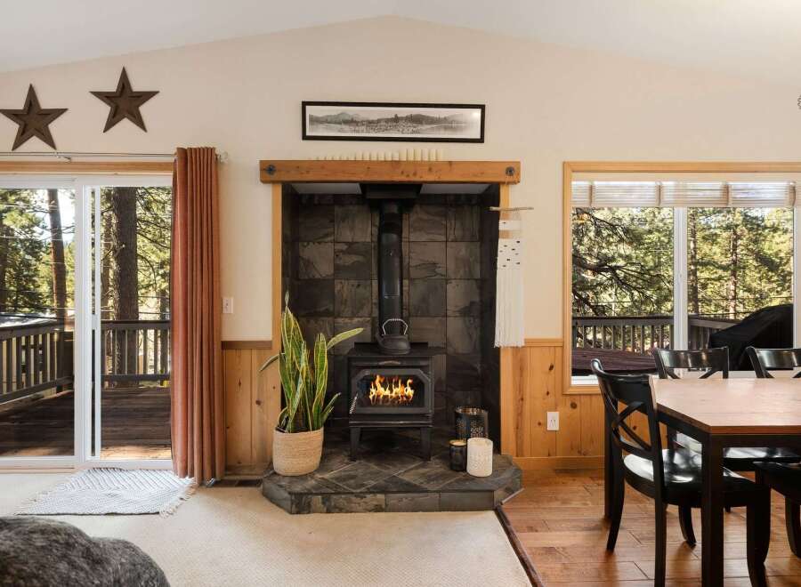 Step into a cozy retreat with this inviting living space, featuring a charming fireplace and a warm, natural aesthetic.