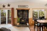 Step into a cozy retreat with this inviting living space, featuring a charming fireplace and a warm, natural aesthetic.