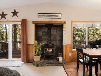 Step into a cozy retreat with this inviting living space, featuring a charming fireplace and a warm, natural aesthetic.