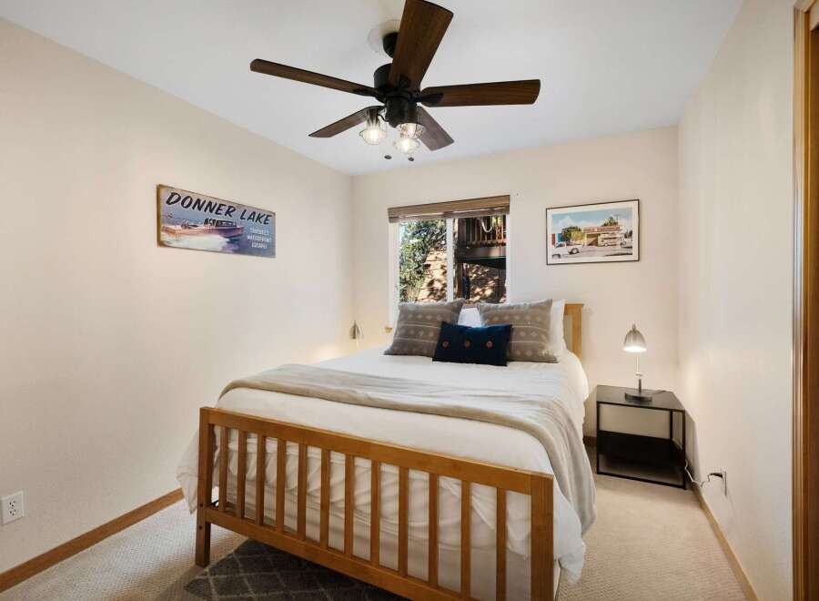 This cozy bedroom features a comfortable bed with soft bedding and decorative pillows, perfect for a relaxing retreat.