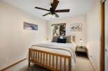 This cozy bedroom features a comfortable bed with soft bedding and decorative pillows, perfect for a relaxing retreat.