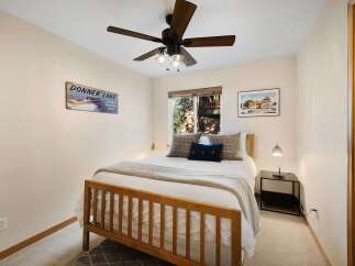 This cozy bedroom features a comfortable bed with soft bedding and decorative pillows, perfect for a relaxing retreat.