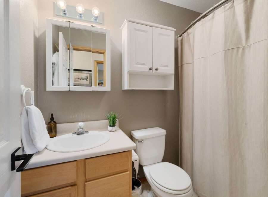 This charming bathroom features a bright and airy design, perfect for starting your day.