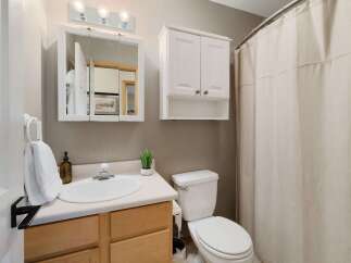 This charming bathroom features a bright and airy design, perfect for starting your day.