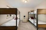 This cozy bedroom features two sets of bunk beds, perfect for accommodating guests or family members.
