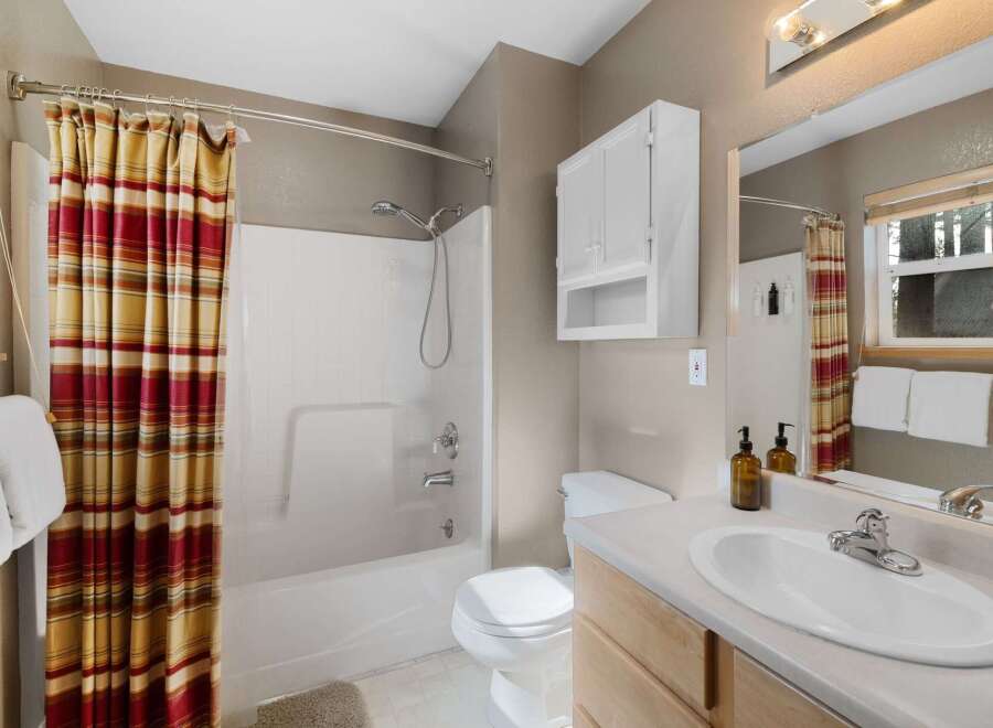 This charming bathroom boasts a bright and airy feel, perfect for starting your day.