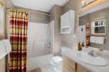 This charming bathroom boasts a bright and airy feel, perfect for starting your day.