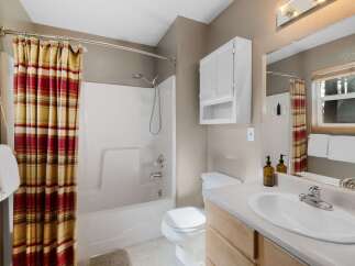 This charming bathroom boasts a bright and airy feel, perfect for starting your day.