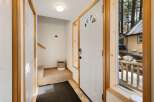 Step into this inviting entryway, featuring a bright white door with a charming arched window.