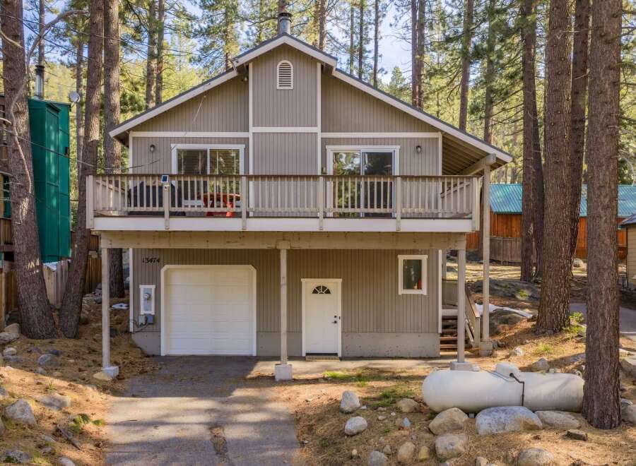 Nestled in a serene wooded setting, this charming home offers a perfect blend of comfort and natural beauty.