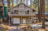 Nestled in a serene wooded setting, this charming home offers a perfect blend of comfort and natural beauty.