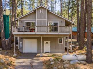 Nestled in a serene wooded setting, this charming home offers a perfect blend of comfort and natural beauty.