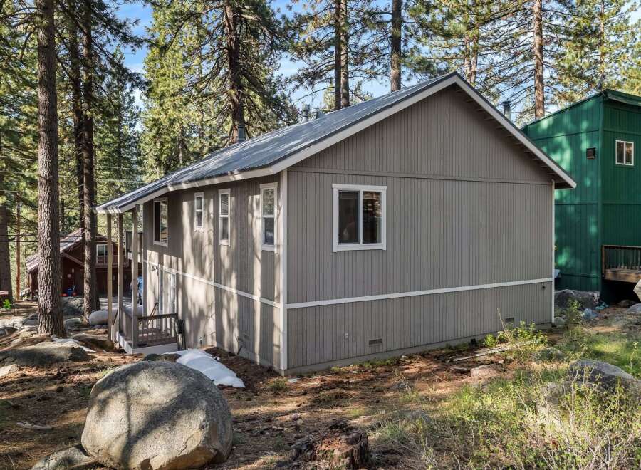 Nestled amidst towering trees, this charming property offers a serene escape.