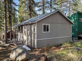 Nestled amidst towering trees, this charming property offers a serene escape.