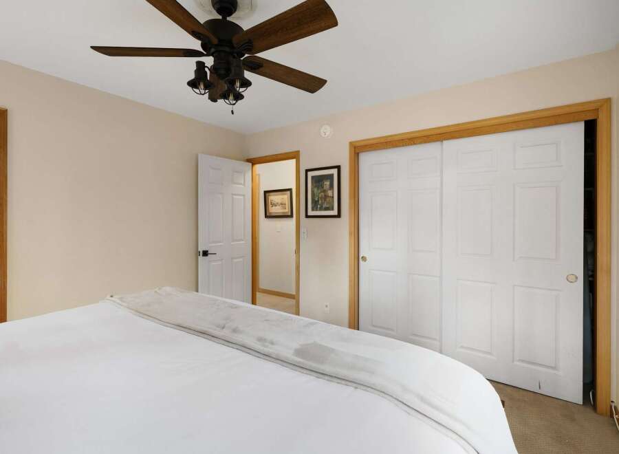 Discover the charm of this inviting bedroom, featuring a cozy bed and ample natural light.