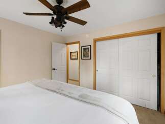 Discover the charm of this inviting bedroom, featuring a cozy bed and ample natural light.