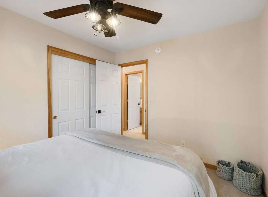 Step into this inviting bedroom, featuring a comfortable bed and ample closet space.