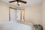 Step into this inviting bedroom, featuring a comfortable bed and ample closet space.
