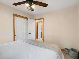 Step into this inviting bedroom, featuring a comfortable bed and ample closet space.