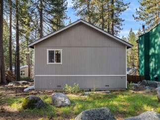 Nestled in a serene, wooded setting, this charming property offers a tranquil escape.