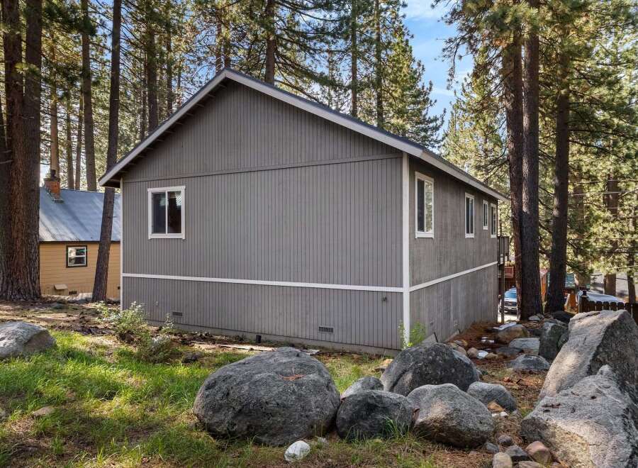 Nestled amidst towering trees, this charming property offers a serene escape.
