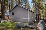 Nestled amidst towering trees, this charming property offers a serene escape.