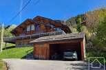 Discover a stunning chalet nestled in a picturesque mountain setting.