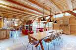 Experience the charm of this stunning property, featuring a spacious dining area with a large wooden table and stylish chairs.