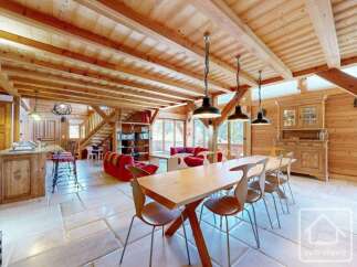 Experience the charm of this stunning property, featuring a spacious dining area with a large wooden table and stylish chairs.