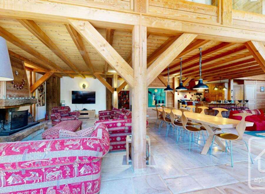 Experience luxury living in this stunning property, featuring a spacious open-plan design with exposed wooden beams and a cozy fireplace.