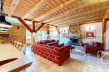 Experience the charm of this stunning property, featuring a cozy living room with a fireplace and exposed wooden beams.