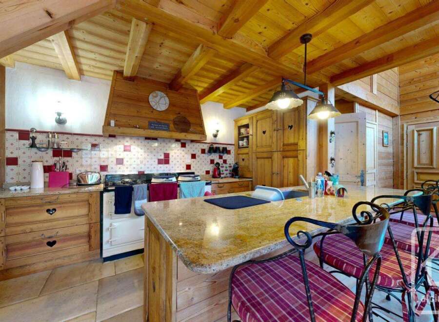 This charming kitchen boasts a rustic design with wooden beams and cabinetry, creating a warm and inviting atmosphere.