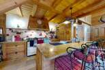 This charming kitchen boasts a rustic design with wooden beams and cabinetry, creating a warm and inviting atmosphere.