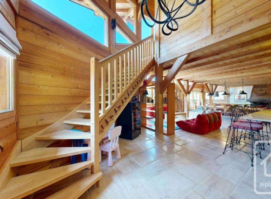 Discover the charm of this stunning property, featuring a beautifully crafted wooden staircase that leads to a spacious living area.