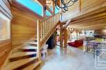 Discover the charm of this stunning property, featuring a beautifully crafted wooden staircase that leads to a spacious living area.