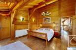 Step into rustic elegance with this stunning bedroom featuring warm wooden accents throughout.