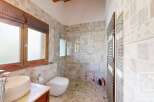 This stunning bathroom features a luxurious design with a walk-in shower, a modern toilet, and a stylish sink.