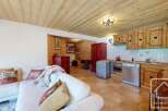 Discover the charm of this cozy property, featuring a rustic kitchen with wooden cabinets and a modern stainless steel dishwasher.